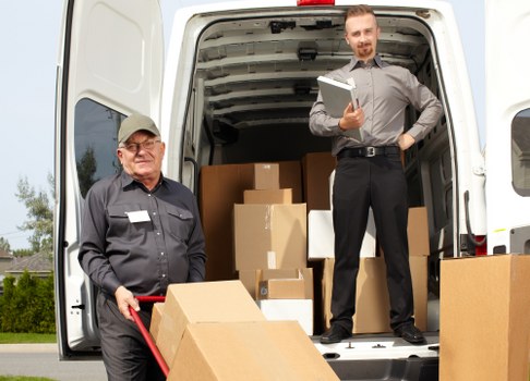 Furniture and boxes being loaded into a removals van