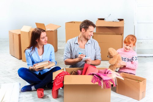 Packed office boxes and IT items for local business relocation