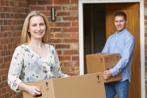Local movers carrying boxes at a Sanderstead property