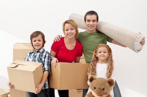 Professional movers handling office equipment during a Sanderstead move