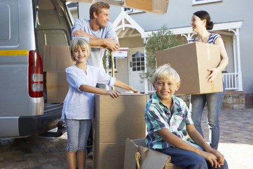 Removal team handling packed boxes and home items for a local move